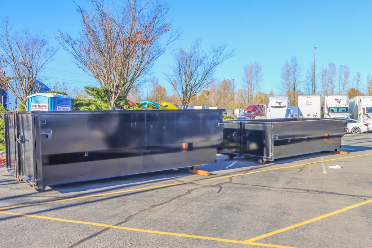 Professional dumpster rental service with roll-off container on residential driveway in Palm River-Clair Mel